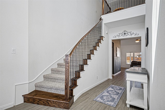 197 Spanish Moss Trl, Rhome, TX 76078 - stairs with a high ceiling, wood finished floors, baseboards, and ceiling fan