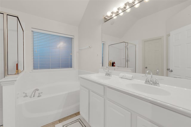 724 Darlington Trl, Fort Worth, TX 76131 - bathroom featuring lofted ceiling, a bath, a shower stall, double vanity, and tile patterned floors