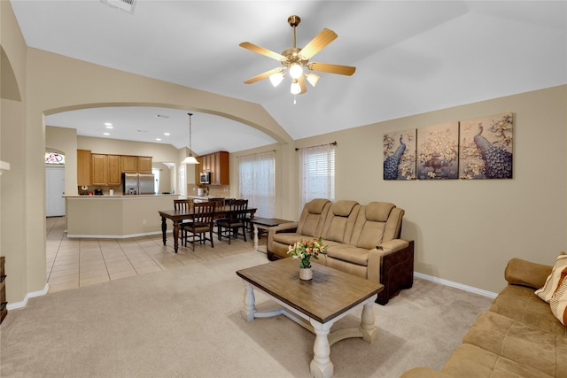724 Darlington Trl, Fort Worth, TX 76131 - living room featuring arched walkways, lofted ceiling, ceiling fan, light carpet, and baseboards