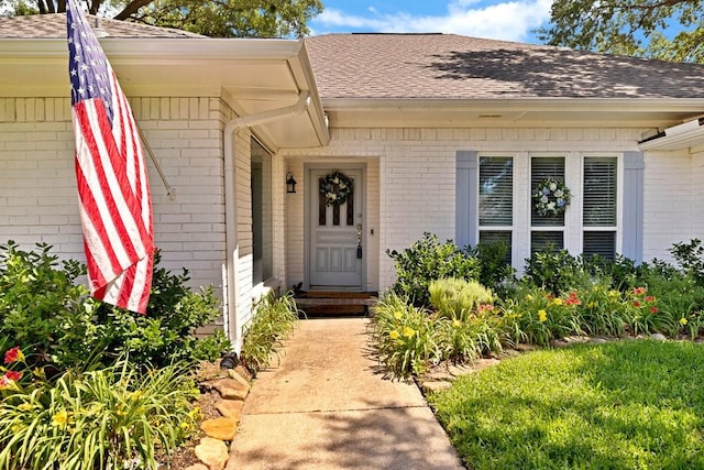 3509 Appalachian Ct, Plano, TX 75075 - view of exterior entry featuring brick siding and a shingled roof
