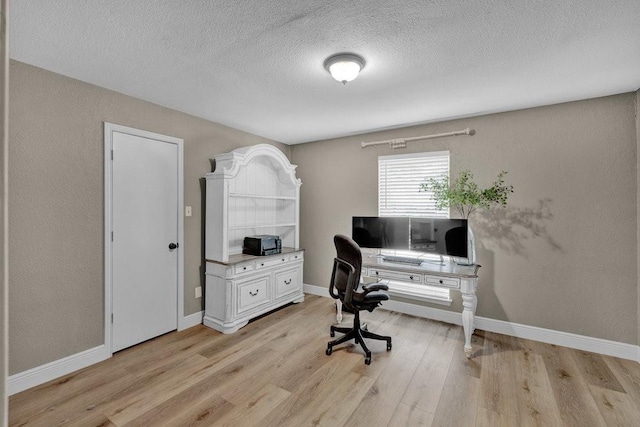 3509 Appalachian Ct, Plano, TX 75075 - home office featuring light wood finished floors, a textured ceiling, and baseboards