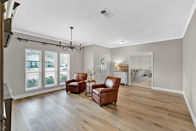3509 Appalachian Ct, Plano, TX 75075 - living area featuring a chandelier, baseboards, light wood finished floors, crown molding, and a textured ceiling
