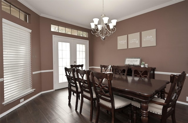 dining room featuring baseboards, a chandelier, ornamental molding, and dark wood finished floors