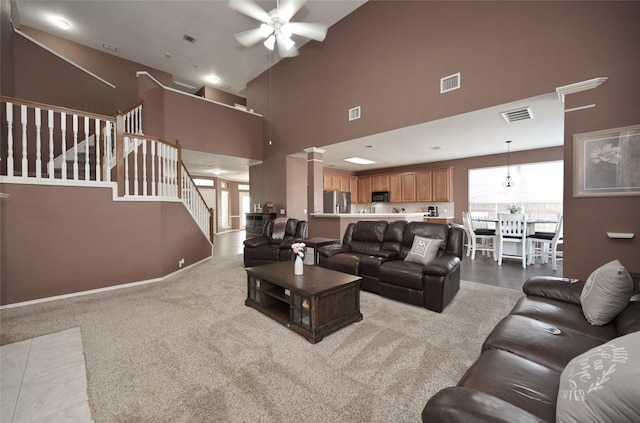 living room featuring high vaulted ceiling, a ceiling fan, and visible vents