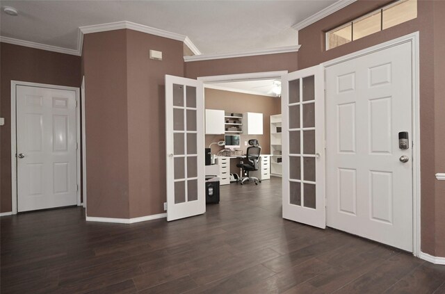 foyer featuring dark wood finished floors, baseboards, ornamental molding, and french doors