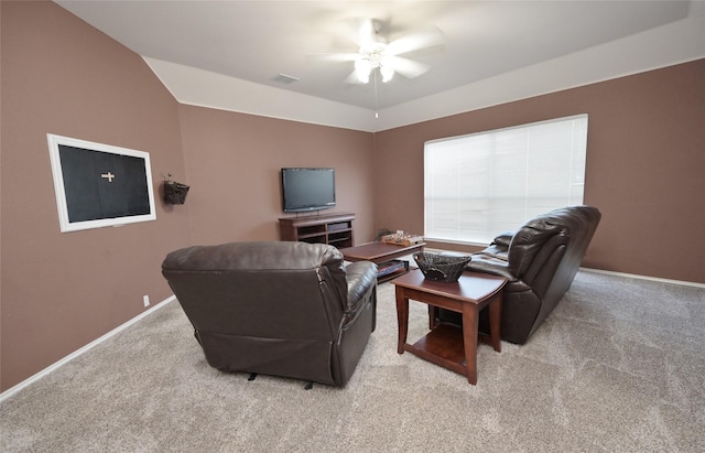 living room featuring light carpet, a ceiling fan, visible vents, and baseboards