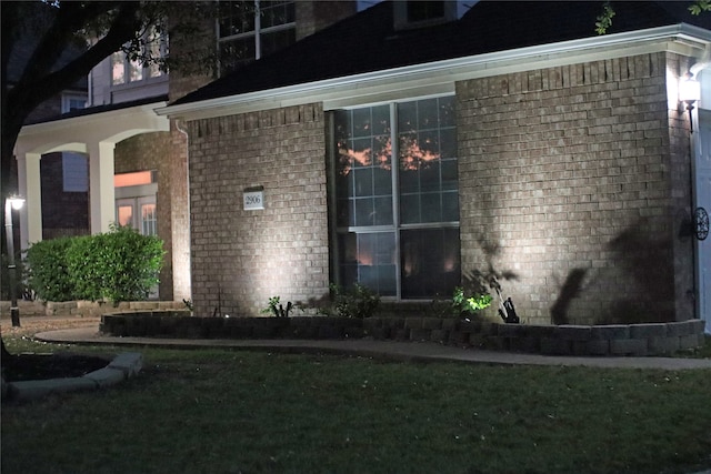 view of side of home featuring brick siding
