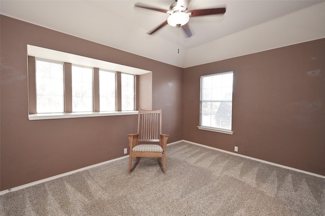 unfurnished room featuring carpet floors, a ceiling fan, and baseboards