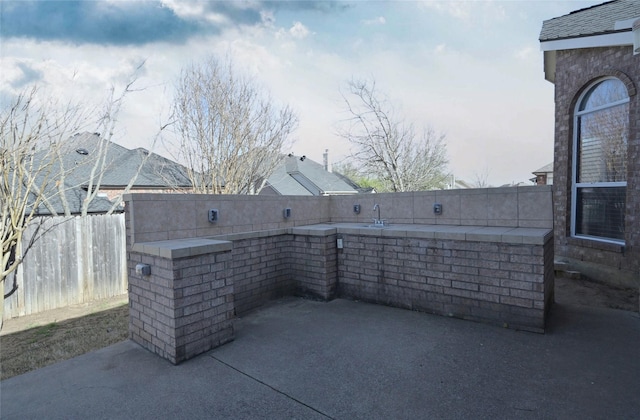 view of patio / terrace featuring fence