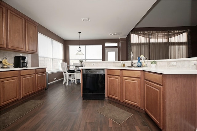 kitchen with plenty of natural light, dishwasher, visible vents, and a sink