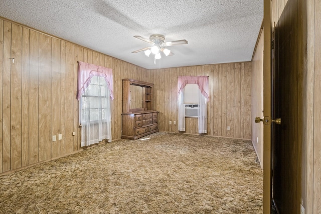 609 E Main, Omaha, TX 75571 - unfurnished bedroom featuring wooden walls, carpet flooring, and a textured ceiling