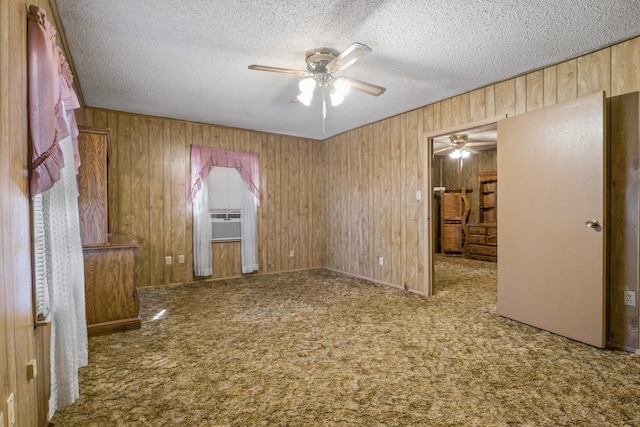 609 E Main, Omaha, TX 75571 - unfurnished bedroom with carpet flooring, a textured ceiling, and wood walls
