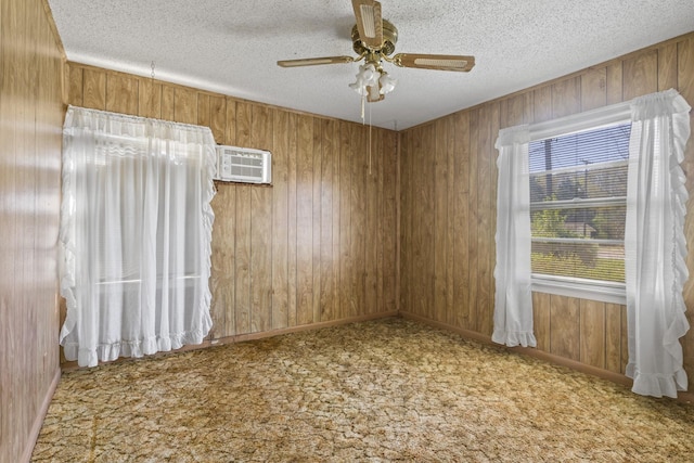 609 E Main, Omaha, TX 75571 - unfurnished room with a wall mounted air conditioner, wood walls, carpet floors, and a textured ceiling