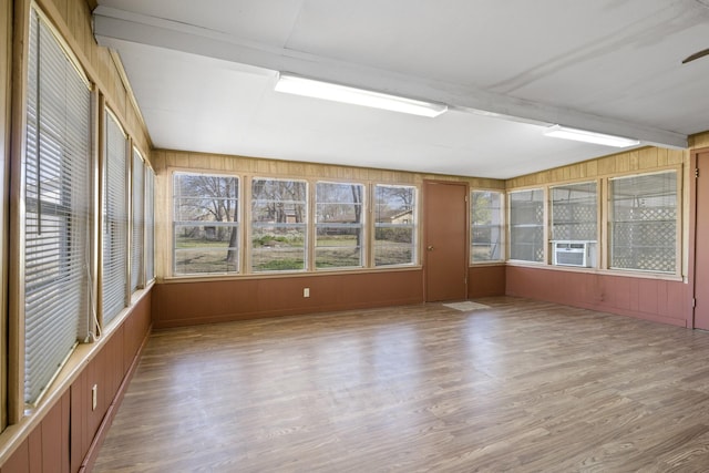 609 E Main, Omaha, TX 75571 - unfurnished sunroom with cooling unit, wood finished floors, a wooden deck, and wood walls