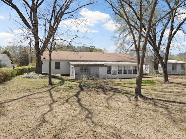609 E Main, Omaha, TX 75571 - rear view of house featuring a sunroom and a yard