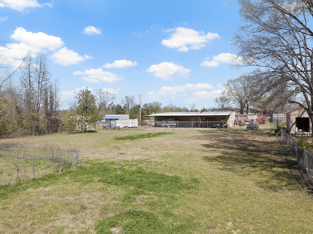 609 E Main, Omaha, TX 75571 - view of yard featuring a pole building, an outbuilding, a carport, and fence