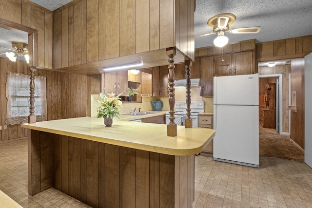 609 E Main, Omaha, TX 75571 - kitchen featuring a ceiling fan, wood walls, ventilation hood, and white appliances