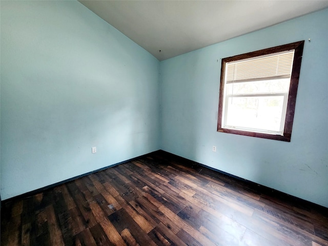 unfurnished room featuring dark wood-style floors