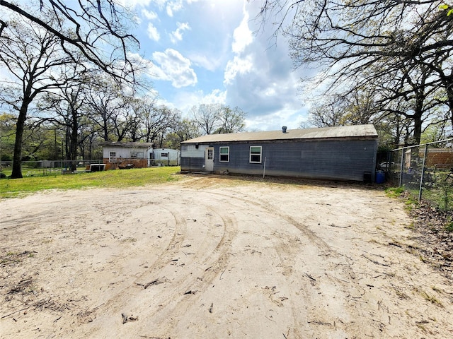 back of house with fence