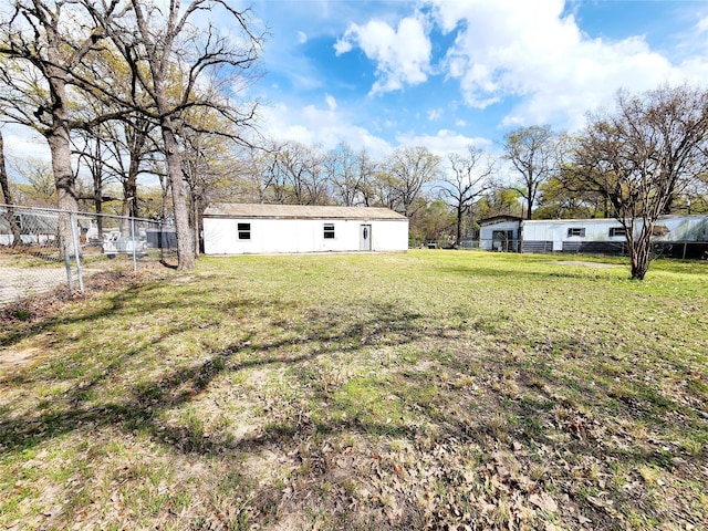 view of yard featuring an outbuilding and fence