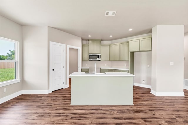 309 Pecan Ln, Tolar, TX 76476 - kitchen with stainless steel microwave, a sink, baseboards, dark wood finished floors, and recessed lighting