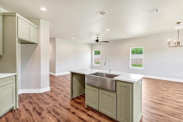 309 Pecan Ln, Tolar, TX 76476 - kitchen featuring a sink, wood finished floors, a center island with sink, light countertops, and baseboards