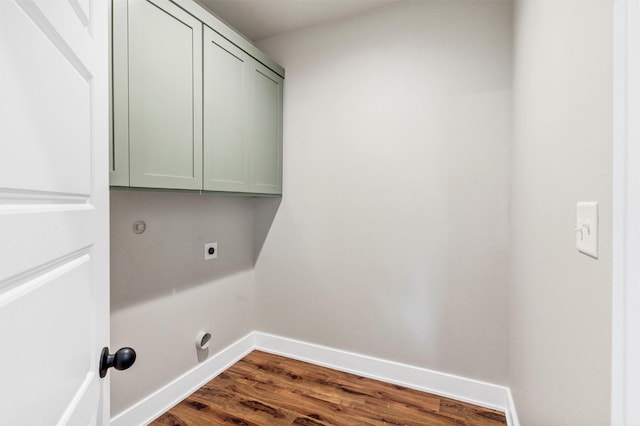 309 Pecan Ln, Tolar, TX 76476 - washroom with electric dryer hookup, cabinet space, dark wood-style flooring, and baseboards