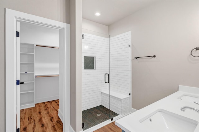 309 Pecan Ln, Tolar, TX 76476 - bathroom featuring a shower stall, a sink, wood finished floors, and a walk in closet