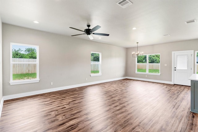 309 Pecan Ln, Tolar, TX 76476 - unfurnished living room with a chandelier, dark wood-style flooring, ceiling fan, baseboards, and recessed lighting