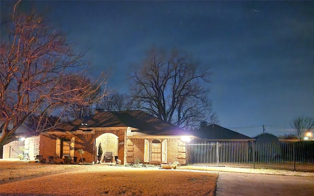 ranch-style home with fence