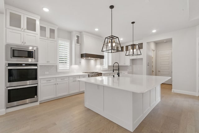 2205 Sandrellan St, Fort Worth, TX 76008 - kitchen featuring appliances with stainless steel finishes, tasteful backsplash, light wood finished floors, light countertops, and white cabinetry