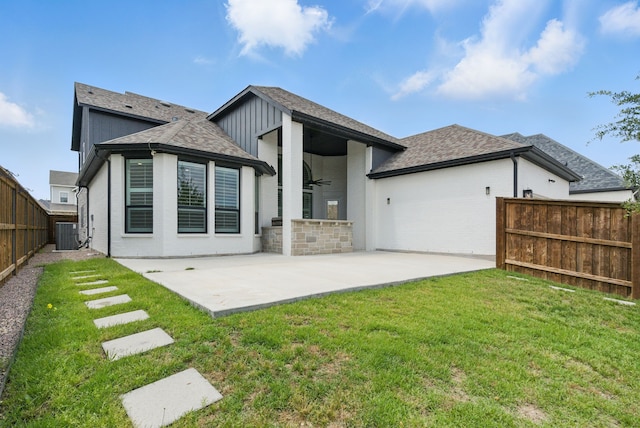 2205 Sandrellan St, Fort Worth, TX 76008 - back of house featuring ceiling fan, a patio, central AC, a shingled roof, and stone siding
