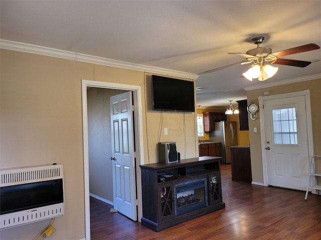 living room with dark wood finished floors, heating unit, ornamental molding, baseboards, and ceiling fan