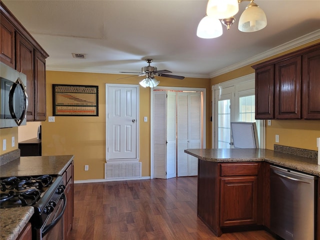 kitchen featuring dark wood-type flooring, stainless steel appliances, visible vents, and ceiling fan with notable chandelier