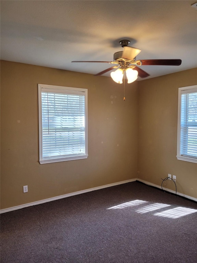 spare room featuring baseboards, a ceiling fan, and carpet flooring
