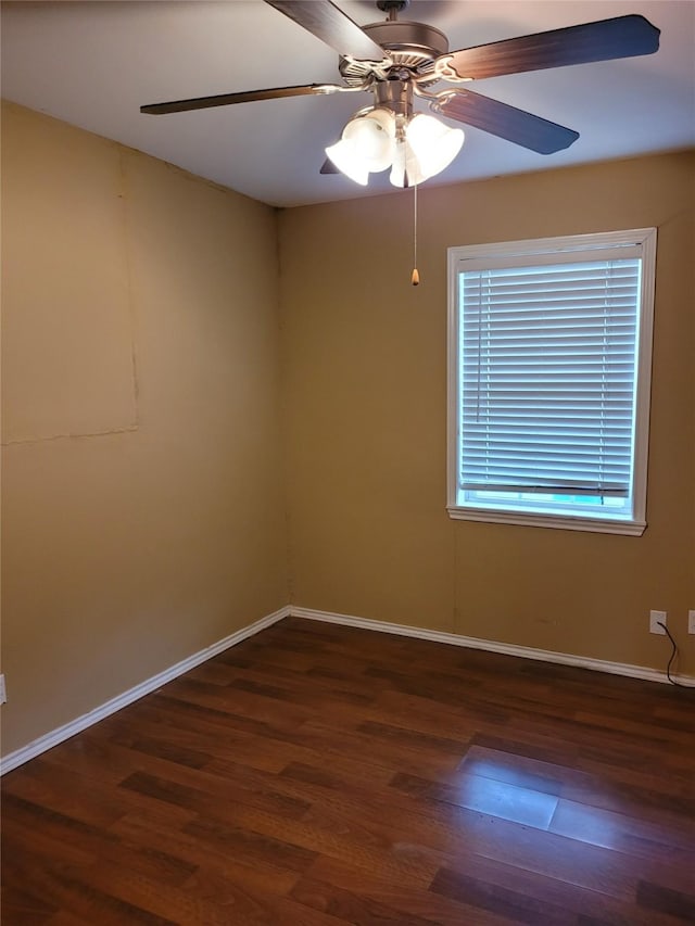 unfurnished room with baseboards, a ceiling fan, and wood finished floors