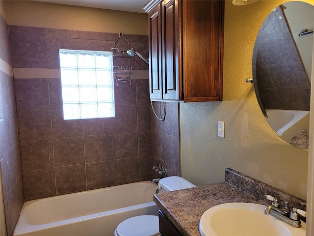 full bath with a textured wall, washtub / shower combination, vanity, and toilet
