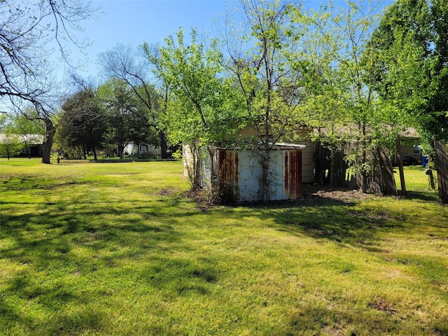 view of yard with an outbuilding and a shed