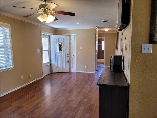 entryway featuring ceiling fan, dark wood-style flooring, crown molding, and baseboards