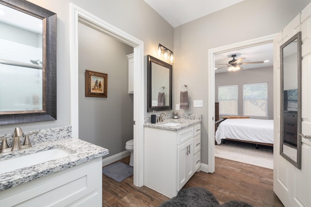 bathroom with ensuite bathroom, ceiling fan, a sink, and wood finished floors