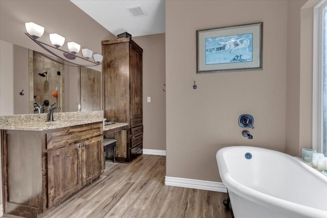 372 Private Road 123, Savoy, TX 75479 - full bath with vanity, baseboards, a freestanding bath, tiled shower, and wood finished floors