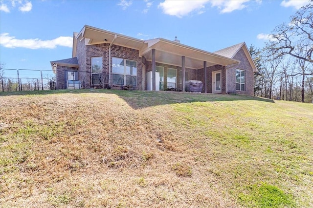 372 Private Road 123, Savoy, TX 75479 - rear view of property with brick siding, fence, and a yard