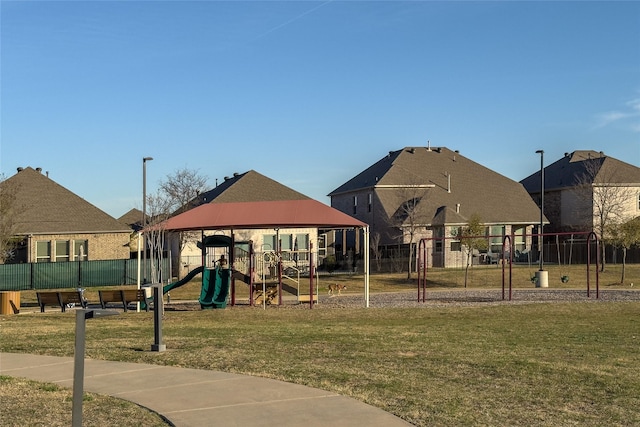 surrounding community featuring fence, a yard, and a playground