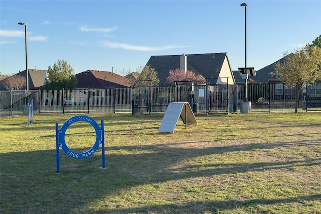view of home's community featuring fence and a yard