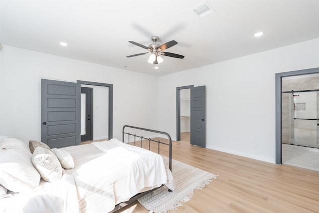 bedroom with recessed lighting, a spacious closet, visible vents, light wood-style floors, and baseboards