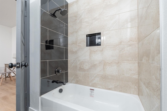 full bath featuring wood finished floors and bathing tub / shower combination