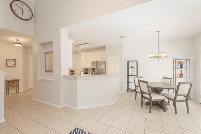 2908 Cranston Pl, Plano, TX 75025 - dining room featuring light tile patterned floors, baseboards, and track lighting