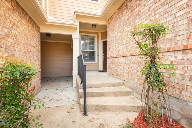 property entrance featuring brick siding