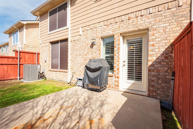 rear view of house with central air condition unit, a patio area, and fence