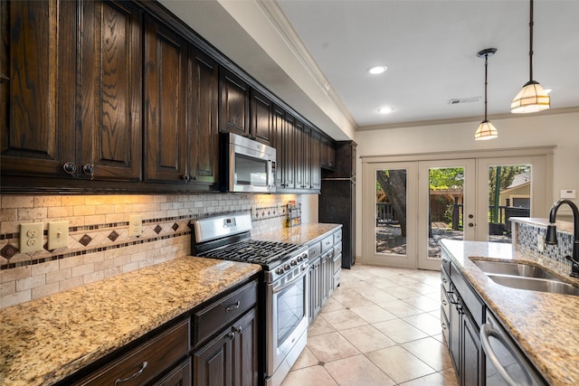 422 S Winnetka Ave, Dallas, TX 75208 - kitchen with appliances with stainless steel finishes, a sink, crown molding, decorative backsplash, and light stone countertops